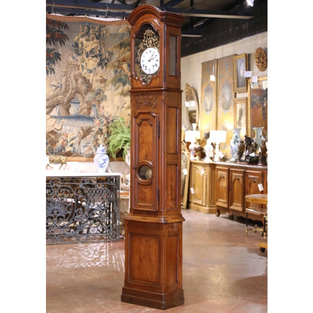 Towering at an impressive nine feet, this antique French longcase, or grandfather clock, was crafted in Lyon circa 1760...