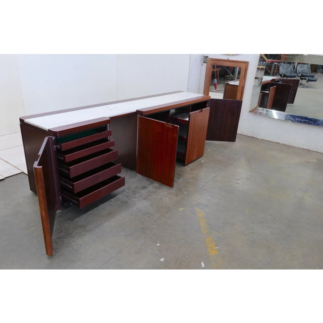 The Mid Century Modern Italian credenza from the 1970s, adorned with a Carrara marble top, is a captivating blend of...