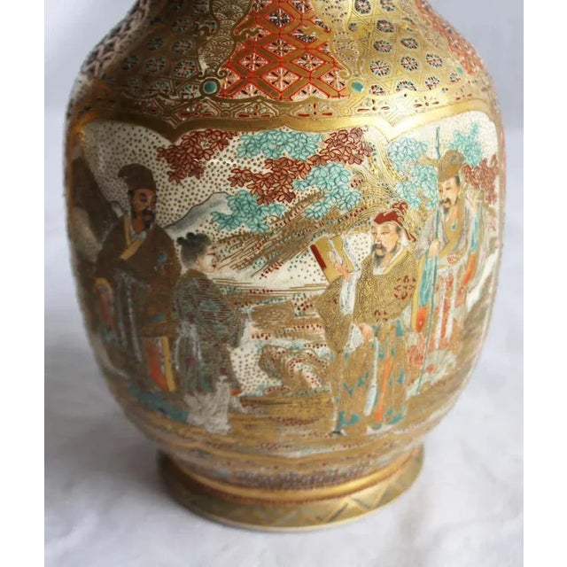 A fine pair of Japanese Satsuma vases. Meiji period (1868-1912). Each of baluster form with wide flared rims. Intricately...