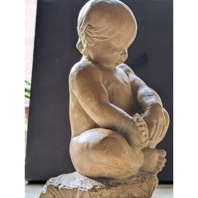 The terra-cotta figure, with oftly rounded limbs, downcast eyes, and a gentle demeanor is typical of works by Albert...