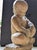 The terra-cotta figure, with oftly rounded limbs, downcast eyes, and a gentle demeanor is typical of works by Albert...