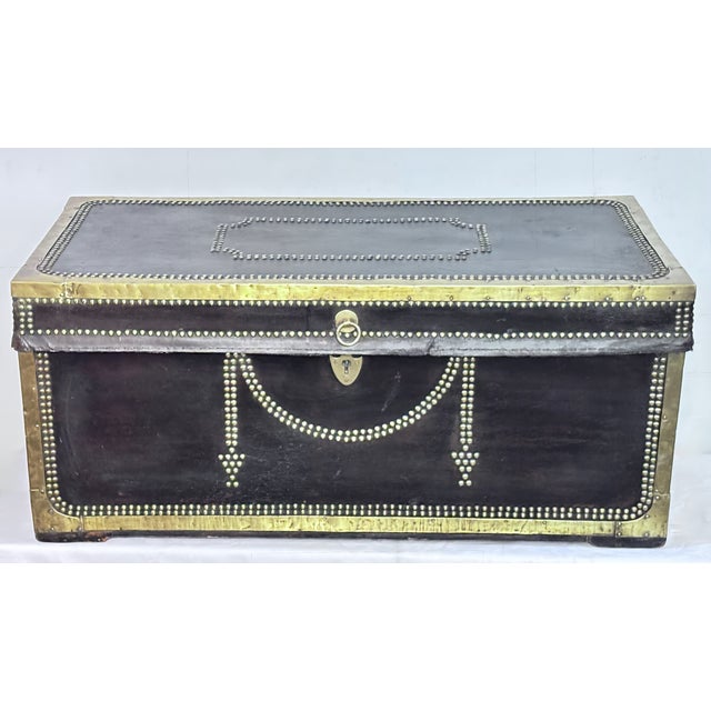 Large antique Chinese Export brass bound dark brown leather camphor wood trunk. These always make for an interesting...