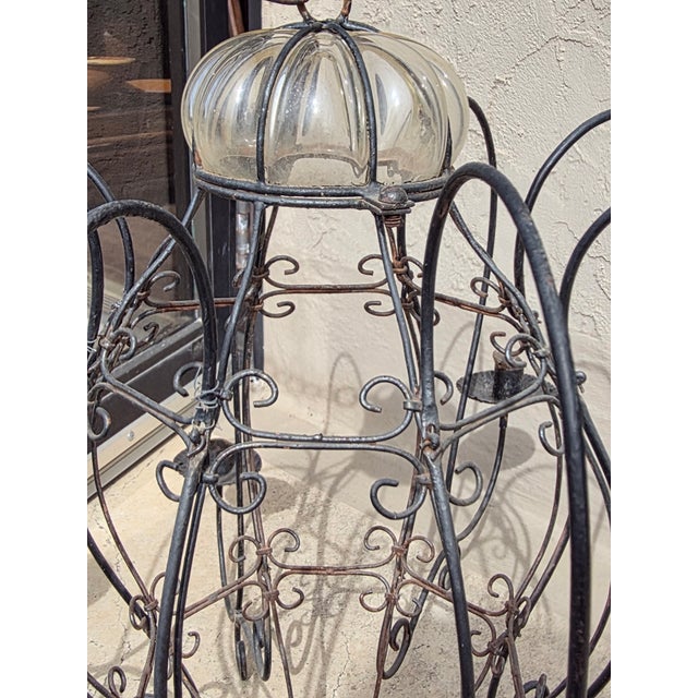 Iron and glass candle chandelier great for a garden or interior use. The height is 21" without the chain. The chain is 44".