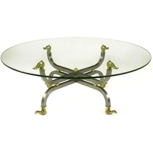 Uncommon gun metal steel and brass mirror image coffee table base with 42" diameter 1/2" thick glass top. Both top and...