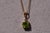 The 199th Street: Solitaire Style Peridot and Diamond Pendant. This classic pendant features a round brilliant cut natural...