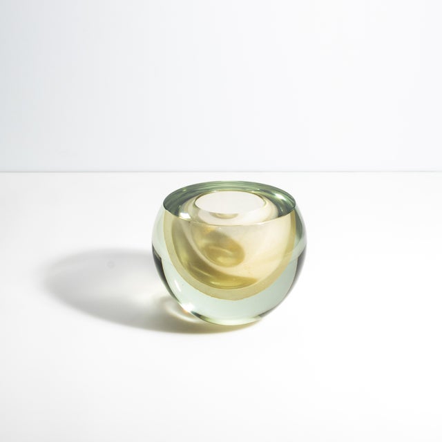 This stunning spherical vase, a masterpiece of Murano glass artistry, showcases the exquisite craftsmanship and intricate...