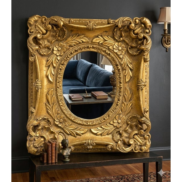 This is one impressive ornate frame with beveled oval mirror. Vibrant gold color.