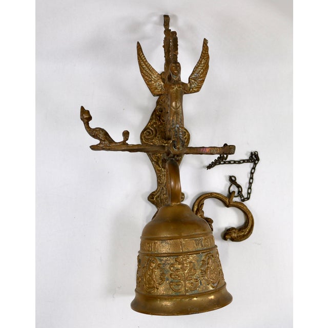 This stunning brass bell has a lovely, resonant ring. It bears a Latin inscription: "Vocem meam audi, qui me tangit,"...