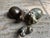 A beautiful set of three carved stone Hippos from Zimbabwe, each rendered in a different colorful variegated stone, the...