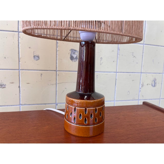 This beautiful vintage Scandinavian table lamp, designed by the Danish brand Søholm, features a warm and distinctive color...