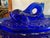 Wow what a piece to use on your table display. This item is a vintage cobalt blue glass covered dish featuring a fish...