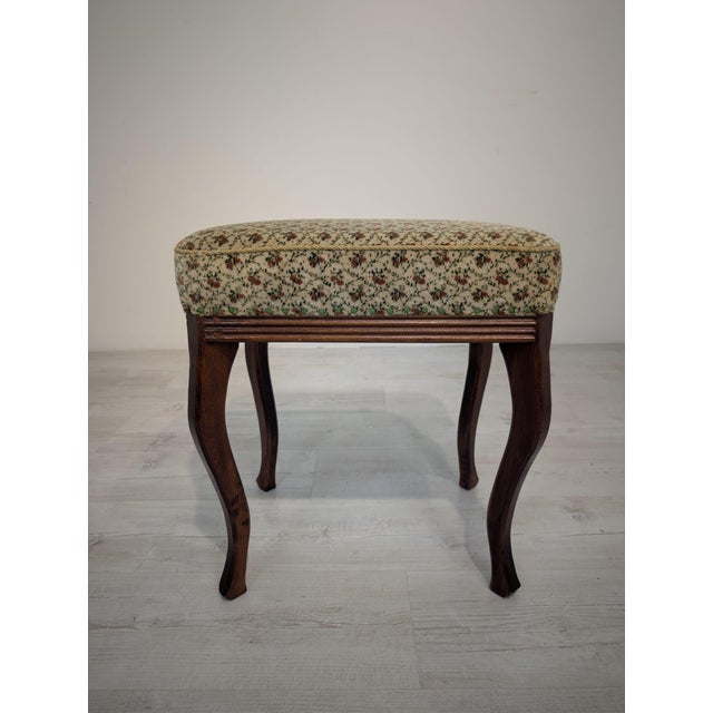 Wooden Louis-style stool and footstool A wooden Louis-style footstool with an upholstered seat in a delicate floral...