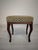 Wooden Louis-style stool and footstool A wooden Louis-style footstool with an upholstered seat in a delicate floral...