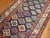 A geometric tribal looking Caucasian Shirvan rug from the early 20th century. Colorful geometric design on a navy blue...