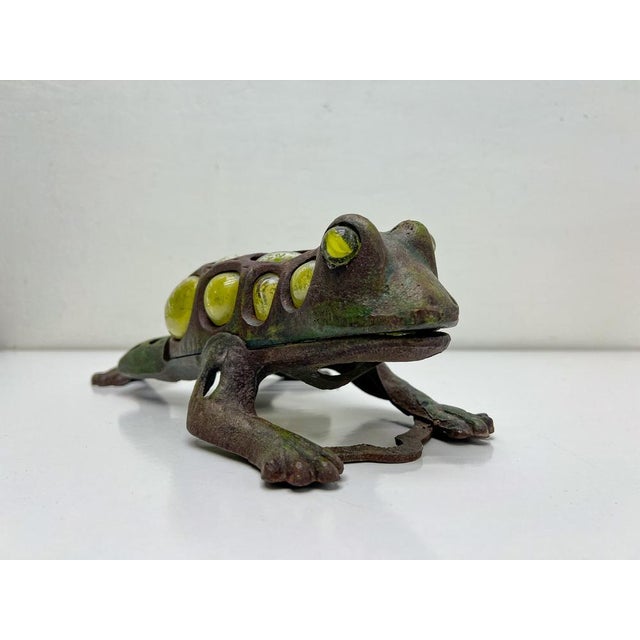 A very attractive old-style garden light -candle holder. It is a crawling frog made of cast iron with bubble glass in...