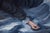 In "Night Swim," a figure reclines serenely amidst swirling waves, evoking a sense of tranquility and introspection. The...