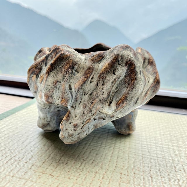 This vintage Chinese ikebana bowl was produced in the Shiwan tradition, known for expressive, sculptural pottery forms...