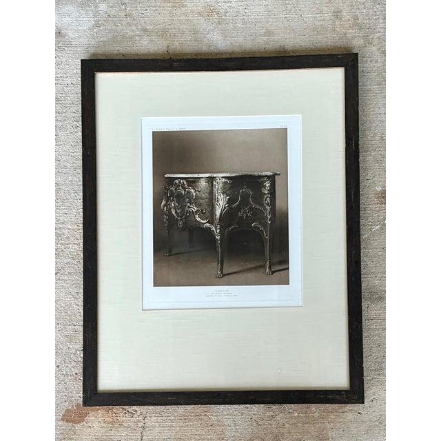 This distinguished framed antique French commode print beautifully captures the elegance and craftsmanship of 18th-century...