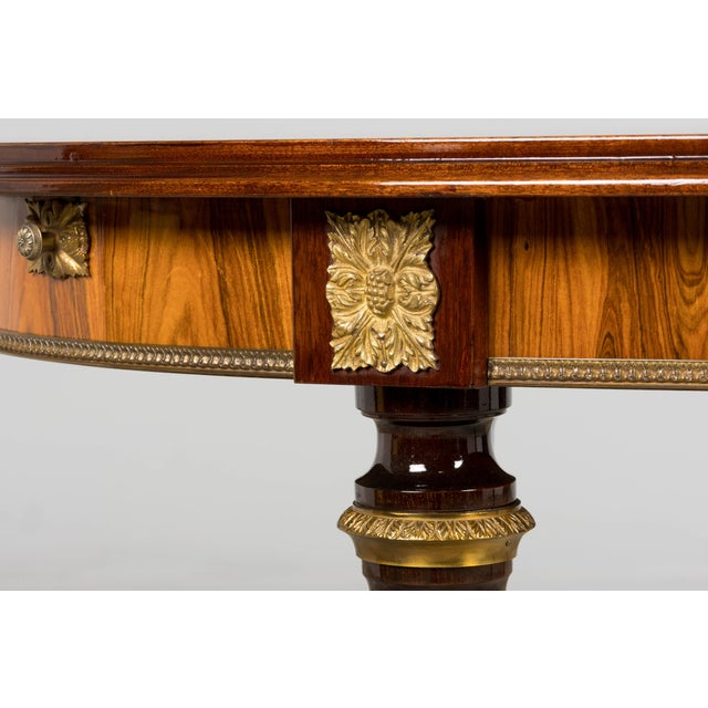 A refined late-19th-century French Louis XVI style dining table sourced in Provence. The oval top is beautifully crafted...