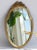 A vintage French gold gilt mirror. The beautiful mirror has an ornate frame with a bow on the top. It has a nice oval...