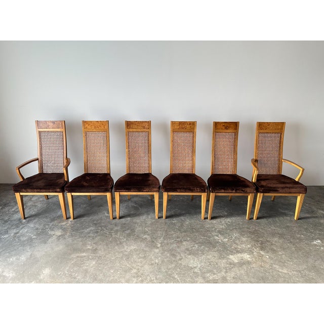 These vintage dining chairs bring texture and height to a table in equal measure. Tall cane backs are framed in warm burl...