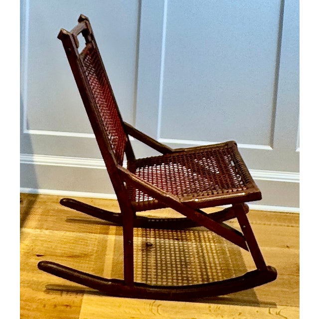 Stamped “Hunzinger” and “Pat. April 18, 1876,” this American Aesthetic Movement walnut rocker features Hunzinger’s...