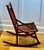 Stamped “Hunzinger” and “Pat. April 18, 1876,” this American Aesthetic Movement walnut rocker features Hunzinger’s...