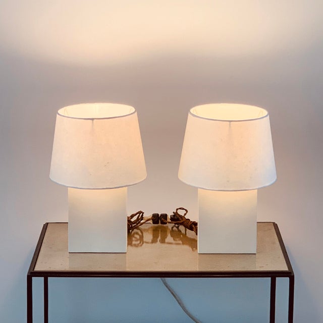 Pair of 'Bloc' parchment lamps with parchment paper shades by Design Frères. The overall dimensions are 10 in. diameter x...