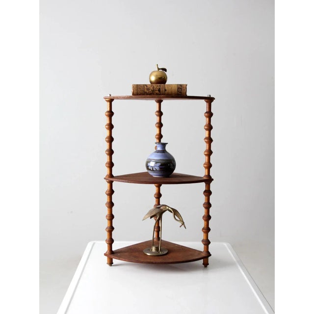 This is an antique folk art spool shelf. Wooden sewing spools decorate and form the framing of this hand-crafted tabletop...
