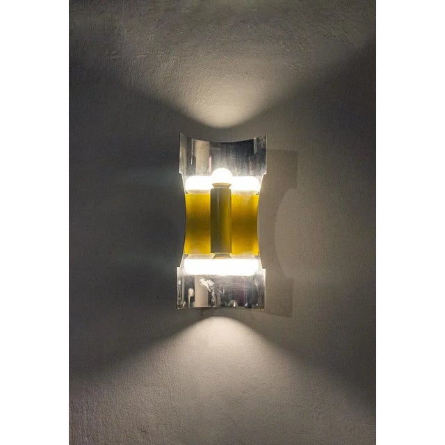 Applique two steel lights and yellow lacquered metal. Space Age style Italian Light Manufacturer 60's I have official...