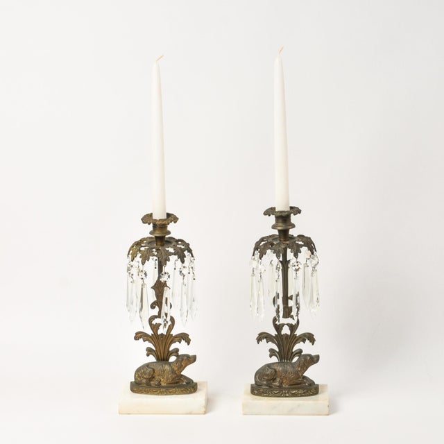 A unique pair of crystal girandoles each featuring a reclining spaniel dog in brass atop a marble base with ornate details...