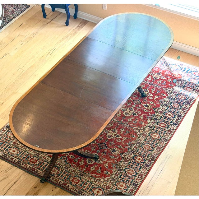 A generously scaled vintage dining set with genuine documented history for 2 chairs. The double-pedestal table has a...