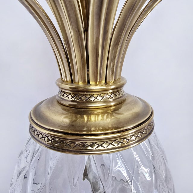 A beautifully crafted Hinkley solid brass pineapple hanging pendant from the Plantation Collection, featuring a cut optic...