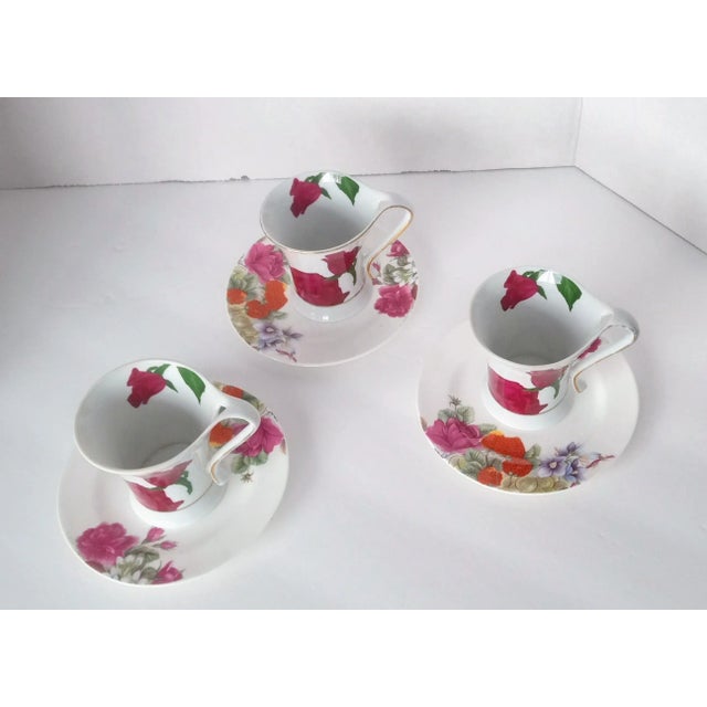 It is a colorful vintage set of three art nouveau porcelain demitasse/coffee cups with floral motifs made by Casati from...