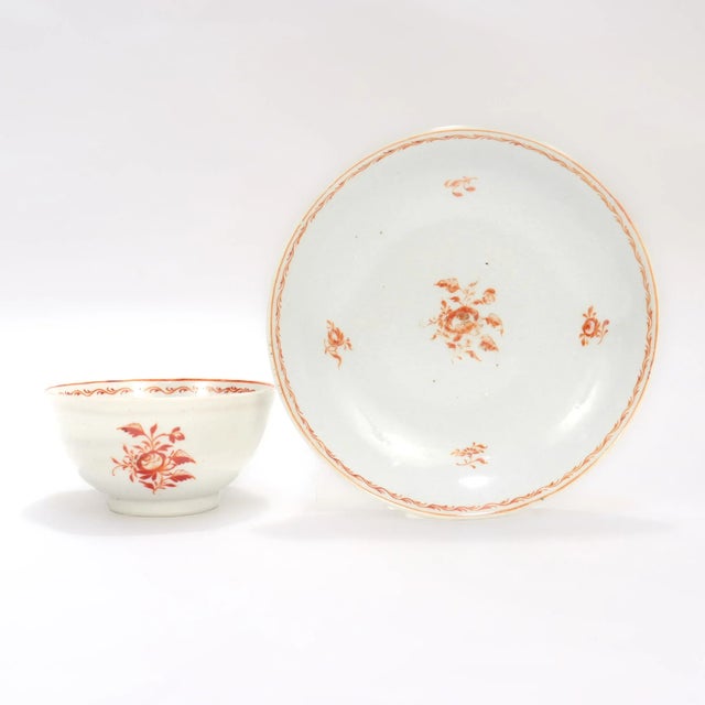 A fine antique Chinese porcelain tea cup and saucer. With orange floral painted decoration on a cream porcelain ground....