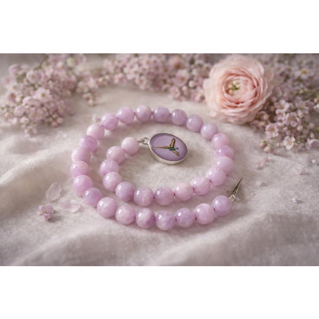 An elegant natural kunzite bead necklace measuring 18 inches (45.7 cm) in length. The smooth, round beads measure...