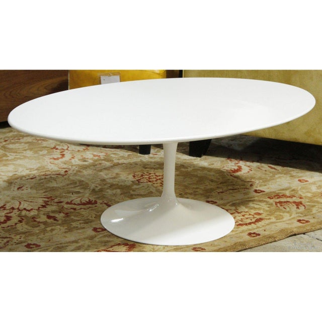This piece features a smooth white oval top supported by a sculptural pedestal base that gives it a clean, uninterrupted...