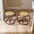 Sculptural pair of vintage bent rattan stools or side tables featuring a striking circular framework and woven cane tops....
