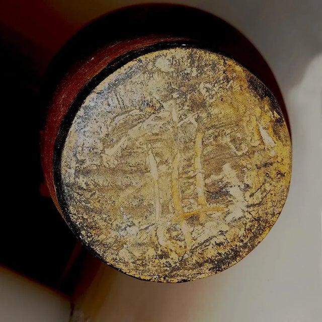 This large vase is a terracotta sculpture with abstract decorations in black and white. It is numbered under the base.