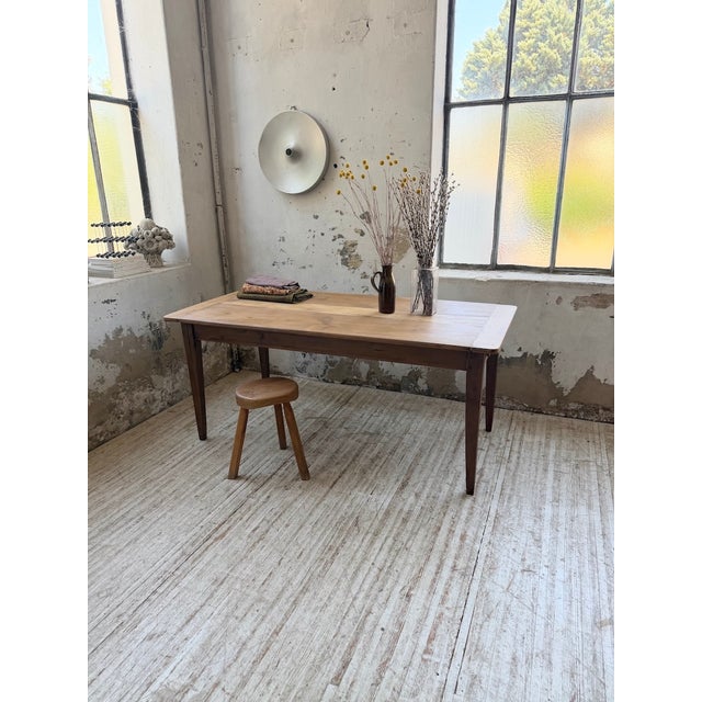 Antique 1950s solid walnut farmhouse table, entirely pegged. we love its exquisitely tapered legs, giving it an elegant,...