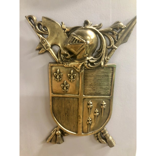 Lovely vintage French solid brass plaque featuring a large family crest coat of arms decorated with fleur-de-lis.