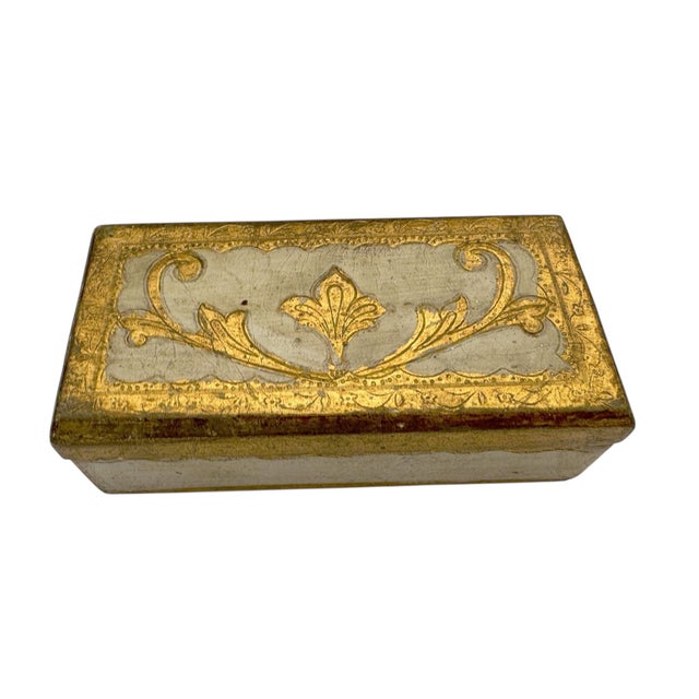 A hand painted wooden box from Italy, adorned with traditional gold leaf and soft ivory tones. Designed for holding stamps...