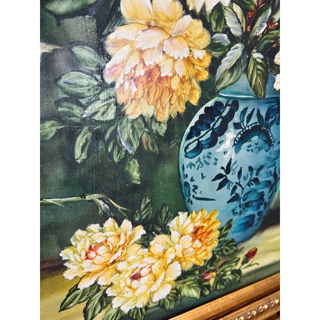 Beautiful vintage oil painting featuring a bouquet of roses and daisies in a blue-and-white vase, housed in an ornate gold...