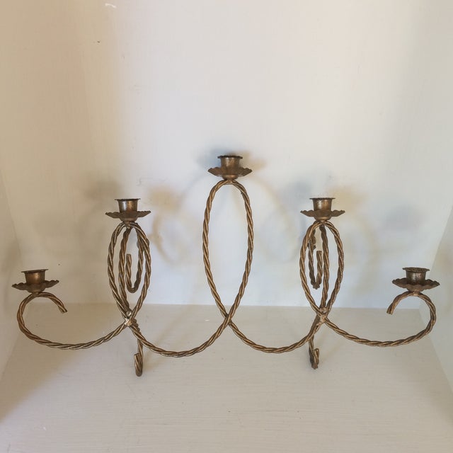 Vintage pair of Italian twisting wire wall sconces. They each have 5 candle holders with drip bobeches and a gold gilt...