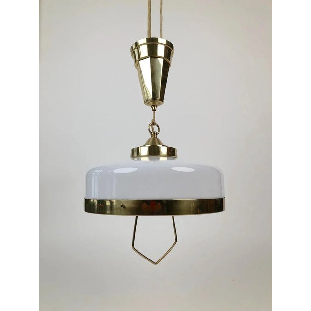 Adjustable jugendstil chandelier with white opaline glass. It was produced in Austria, circa 1923. The electrical wiring...