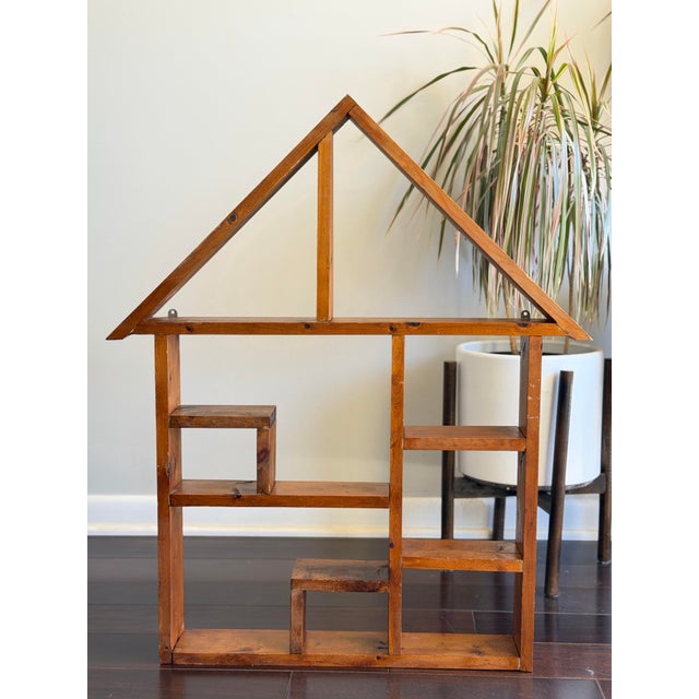 Antique handmade house-shaped wall shelf crafted from solid wood, featuring a charming architectural silhouette with...