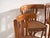 A set of four antique chairs in bentwood, with a curved crest rail over vertical splats and a moulded board seat....