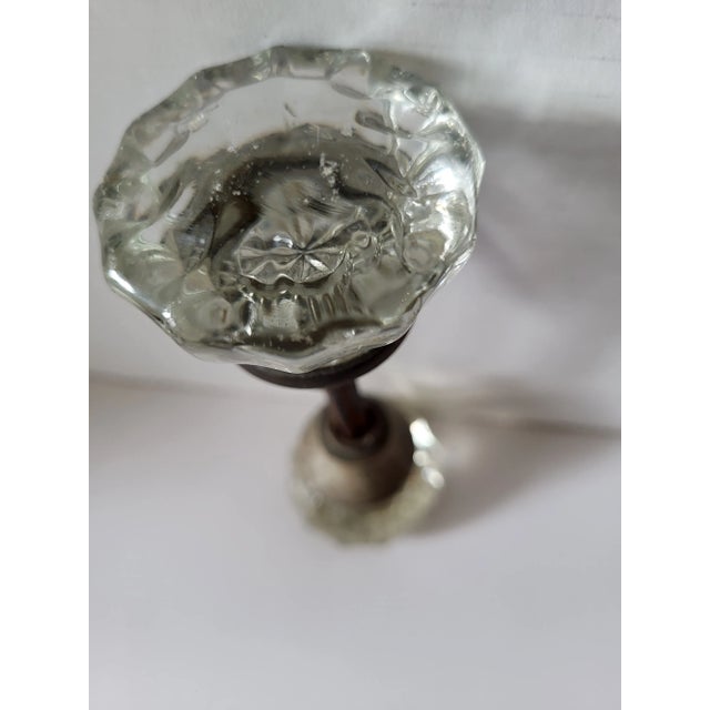 Glass door knob. 12 sided glass top with center rosette pattern. From house in philadelphia. Both set screws in place....