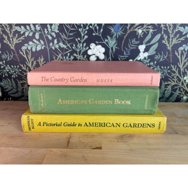A charming stack of vintage gardening books in cheerful, earthy hues — coral, green, and golden yellow. Filled with...