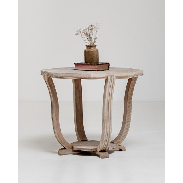A masterpiece of interwar French design, this octagonal coffee table embodies the geometric precision and refined elegance...